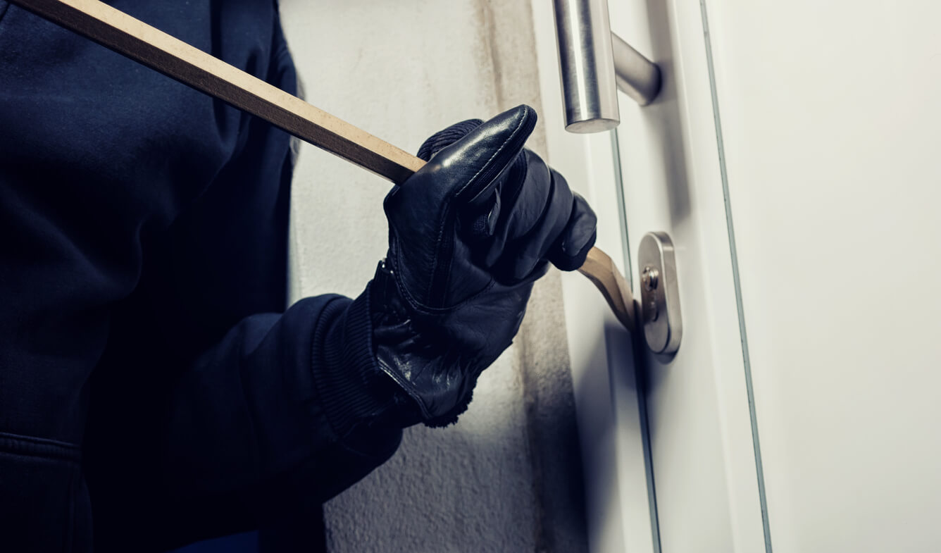 man breaking and entering a home