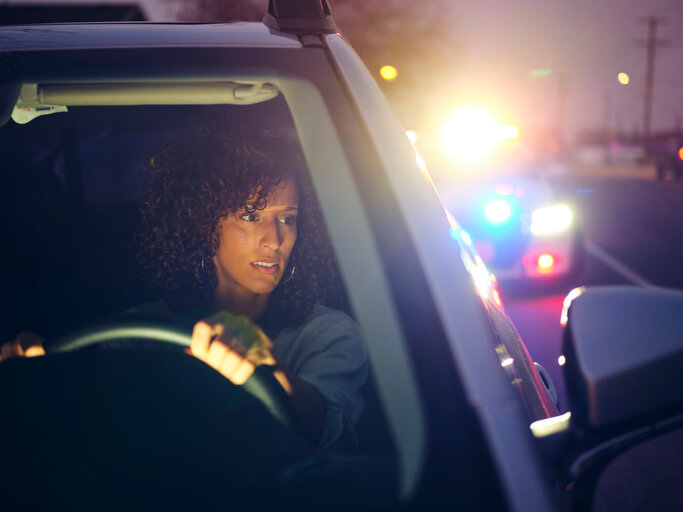 Woman being stopped by police in vehicle