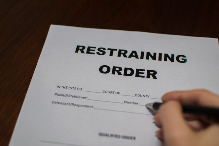 man signing restraining order