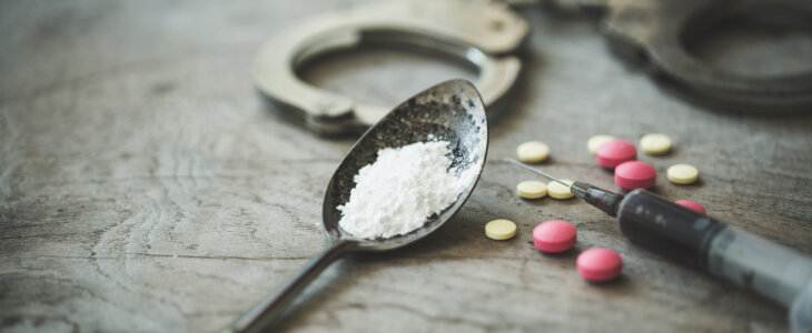 Handcuffs, drugs and syringes on wooden table, Law and police concept, World Anti-drug Day - Image