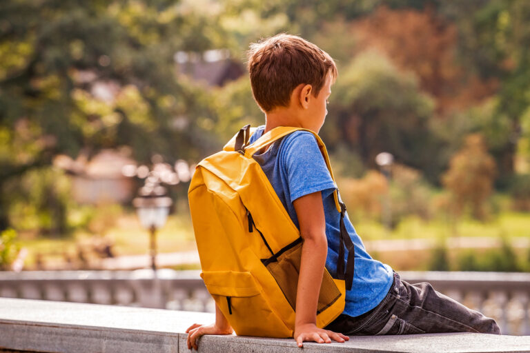 Child sitting on bench alone