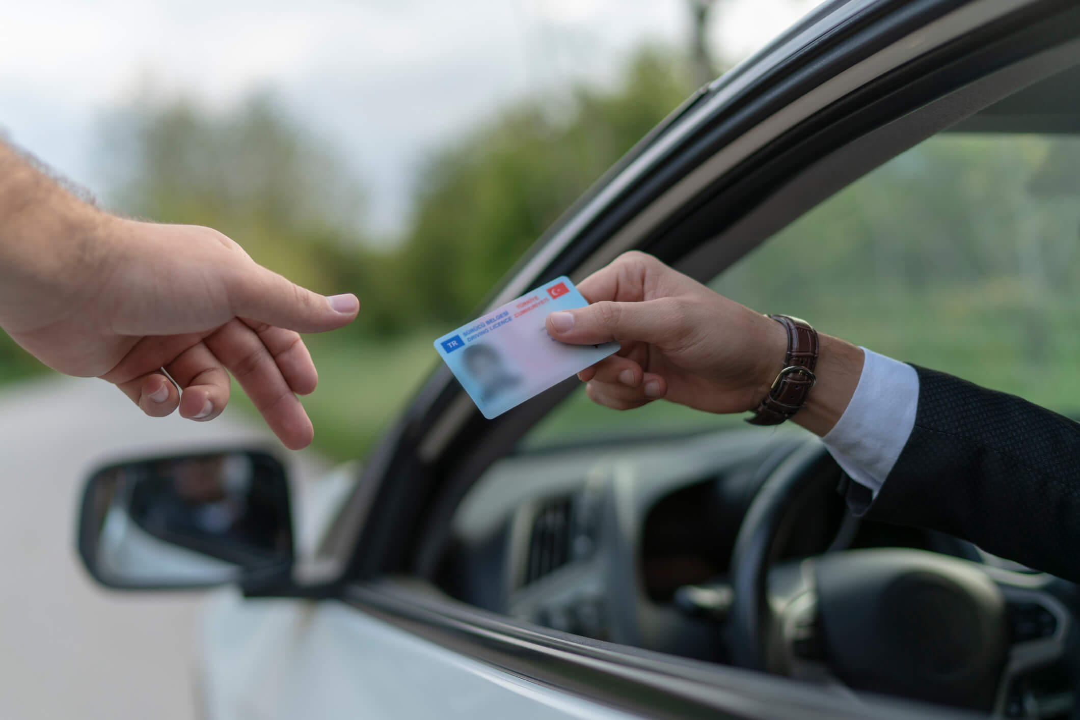 Crime: Policeman gives driver a traffic ticket.
