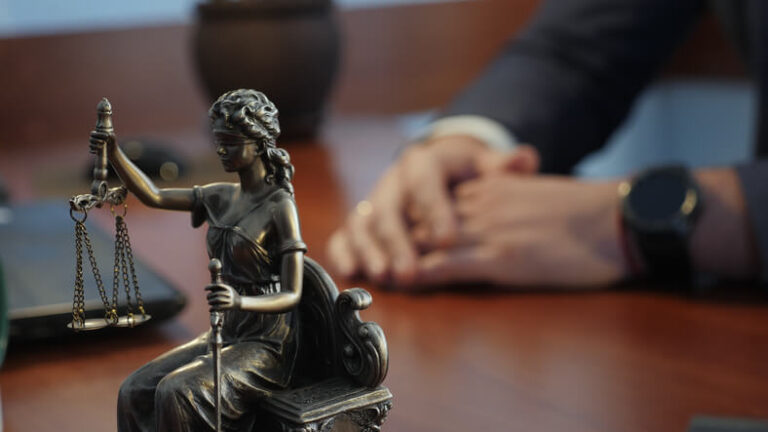 Criminal defense attorney with Justice statue