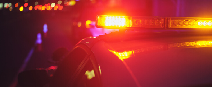 A police car pulling over a driver for DWI