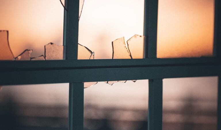 Broken glass in a window pane at sunset