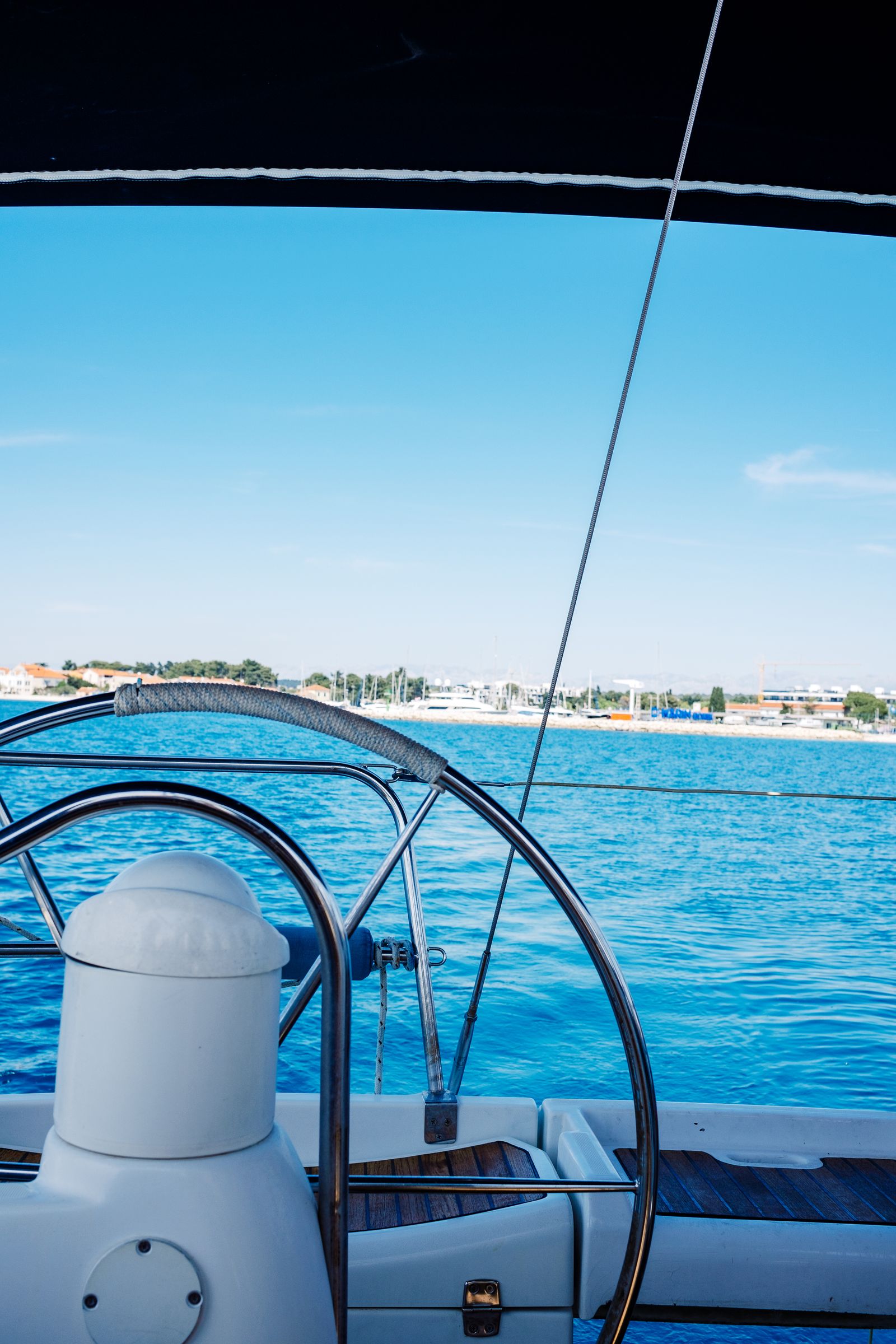 View of open water from the helm of a boat