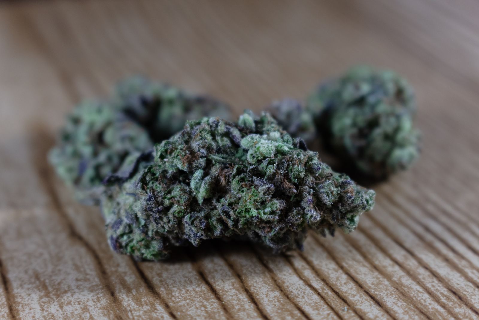 Close-up of marijuana buds on a wooden surface